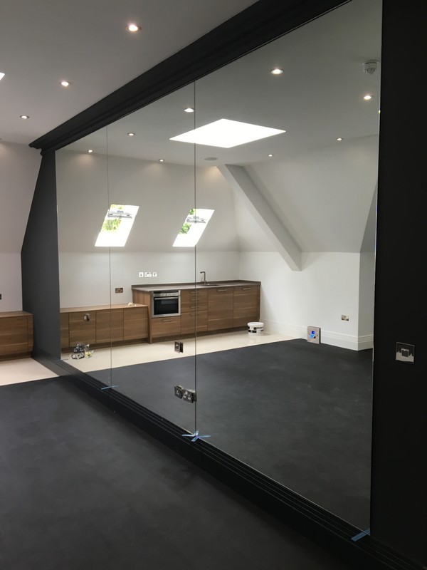 Frameless glass partition in loft conversion by Regent's Park glaziers